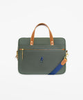 Green handbag with brown handle and blue strap on a white background